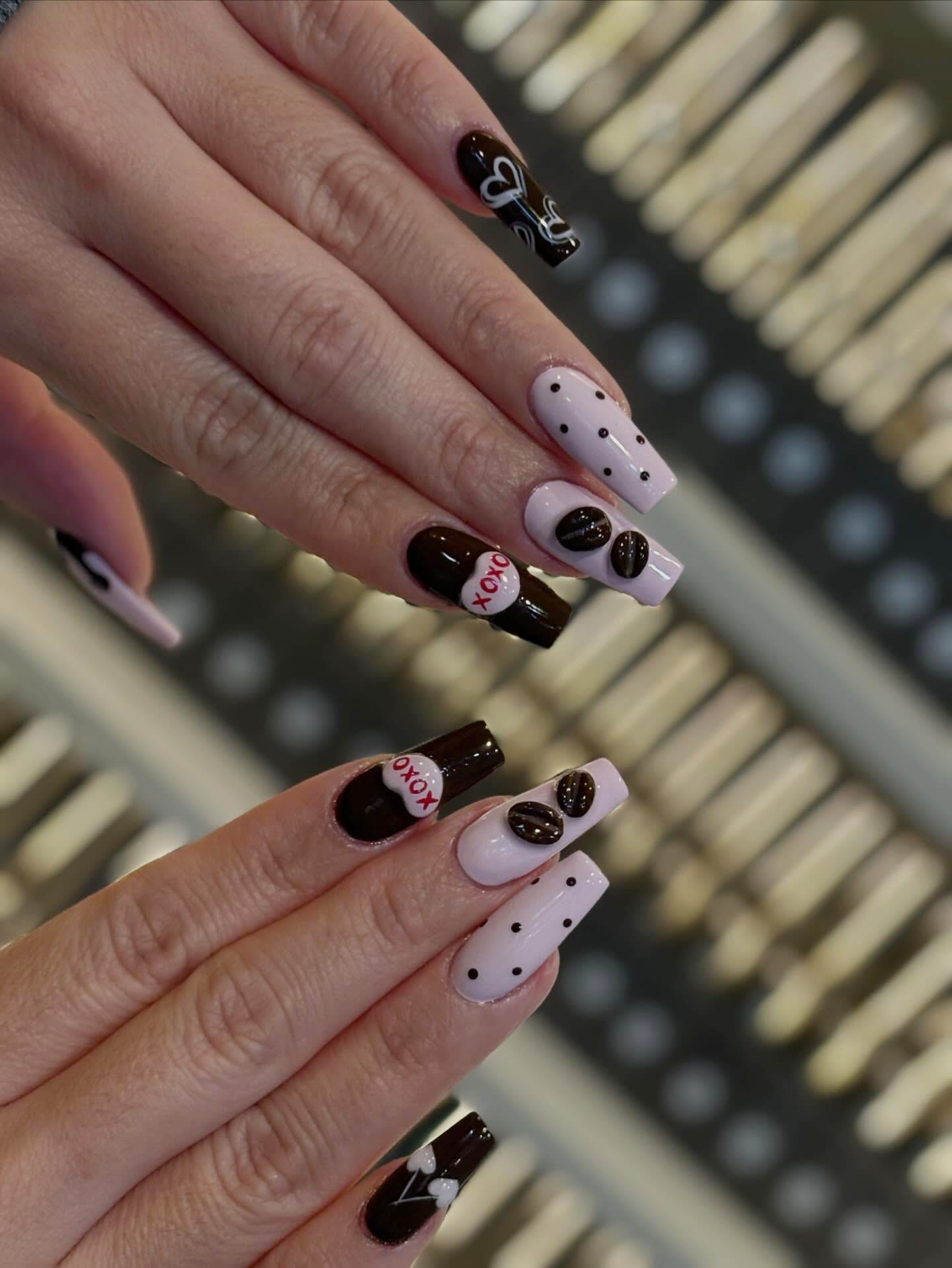 Blush shimmer manicure styled with a pink rose